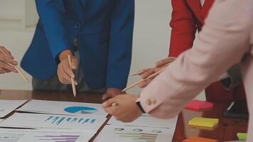 Financial analysts analyze business financial reports on a digital tablet planning investment project during a discussion at a meeting of corporate showing the results of their successful teamwork. video