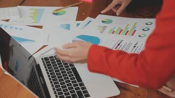 Financial analysts analyze business financial reports on a digital tablet planning investment project during a discussion at a meeting of corporate showing the results of their successful teamwork. video