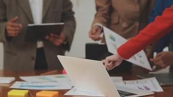 Financial analysts analyze business financial reports on a digital tablet planning investment project during a discussion at a meeting of corporate showing the results of their successful teamwork. video
