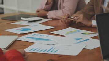Financial analysts analyze business financial reports on a digital tablet planning investment project during a discussion at a meeting of corporate showing the results of their successful teamwork. video