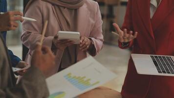 Financial analysts analyze business financial reports on a digital tablet planning investment project during a discussion at a meeting of corporate showing the results of their successful teamwork. video