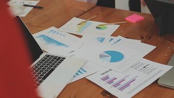 Financial analysts analyze business financial reports on a digital tablet planning investment project during a discussion at a meeting of corporate showing the results of their successful teamwork. video