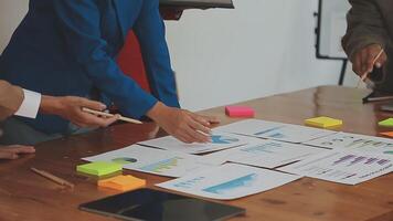 Financial analysts analyze business financial reports on a digital tablet planning investment project during a discussion at a meeting of corporate showing the results of their successful teamwork. video