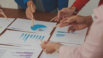 Financial analysts analyze business financial reports on a digital tablet planning investment project during a discussion at a meeting of corporate showing the results of their successful teamwork. video