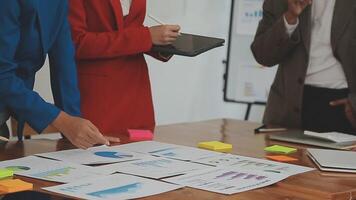 Financial analysts analyze business financial reports on a digital tablet planning investment project during a discussion at a meeting of corporate showing the results of their successful teamwork. video