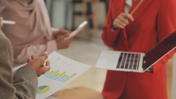 Financial analysts analyze business financial reports on a digital tablet planning investment project during a discussion at a meeting of corporate showing the results of their successful teamwork. video