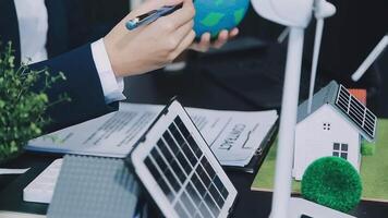 Eco business company meeting with group of business people using laptop to plan strategy and discuss marketing of eco-friendly and clean energy products. Green business company concept. Trailblazing video