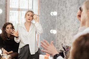 A professional makeup artist conducts a master class on professional development showing makeup practices photo