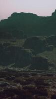 A large mountain with a few rocks on top of it video