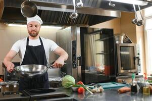 Smiling chef in his kitchen photo