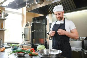 Smiling chef in his kitchen photo