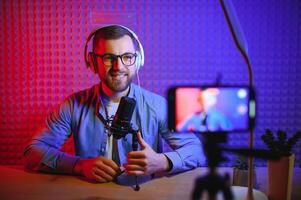 A blogger records content in his studio. The backstage photo was taken from behind one of the participants in the shooting, at the beginning of the shooting when the blogger is preparing.