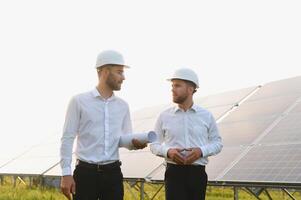 Project manager discuss with worker installation process of solar panel photo