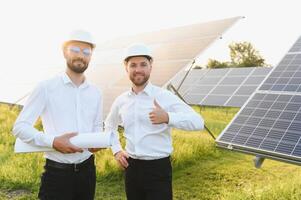 engineer and businessman planing new ecology project. around solar panel roof photo