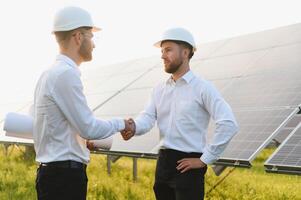 Project manager discuss with worker installation process of solar panel photo