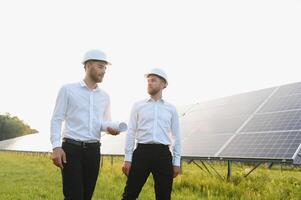 Project manager discuss with worker installation process of solar panel photo