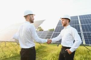 engineer and businessman planing new ecology project. around solar panel roof photo