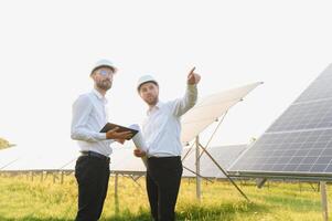 Project manager discuss with worker installation process of solar panel photo