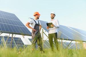 engineer and businessman planing new ecology project. around solar panel roof photo