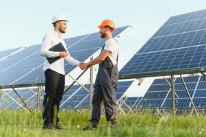 engineer and businessman planing new ecology project. around solar panel roof photo