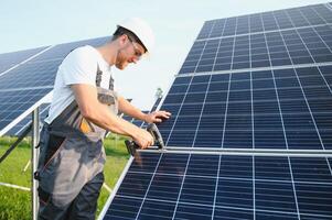 Worker installing solar panels outdoors photo