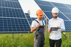 engineer and businessman planing new ecology project. around solar panel roof photo