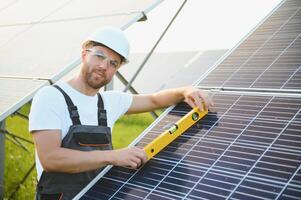 Worker installing solar panels outdoors photo