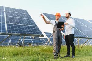 engineer and businessman planing new ecology project. around solar panel roof photo