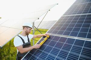 Worker installing solar panels outdoors photo