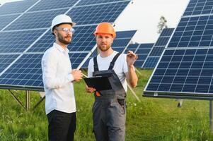 engineer and businessman planing new ecology project. around solar panel roof photo