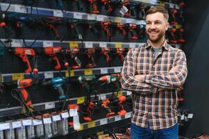 handsome young man shopping for tools at hardware store photo
