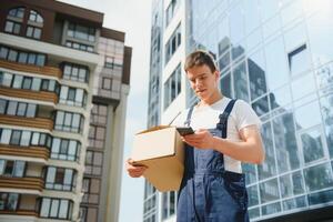 A man carrying package from delivery car - courier service concept photo