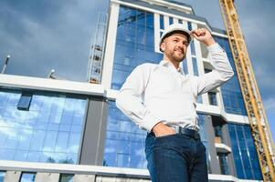 Architect in helmet near new building photo