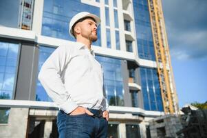 Architect in helmet near new building photo