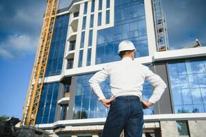 A construction worker control a pouring concrete pump on construction site and sunset background photo