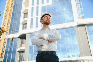 Architect in helmet near new building photo