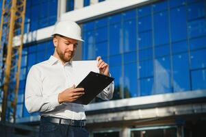 Portrait of building inspector with digital tablet on construction site photo