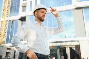 Architect in helmet near new building photo