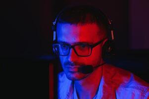 Handsome young male software developer programming codes while working from home photo