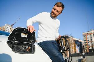 Man turning on charging of car photo