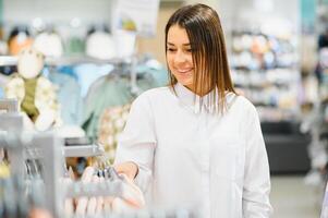 Beautiful woman shopping for clothes at a store photo
