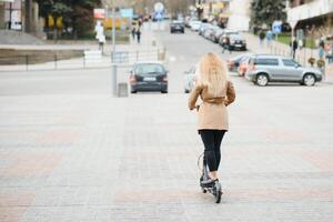 Portrait of a young woman with electro scooter photo