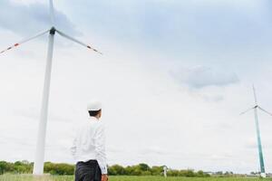 Windmill engineer inspection and progress check wind turbine at construction site. photo