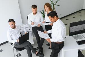 Team of brokers is working in office using workstation and analysis technology. photo