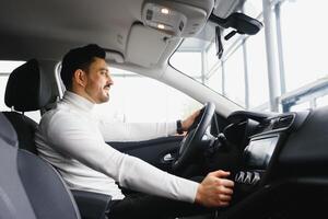 Male hand on the shift lever of the transmission in the car photo