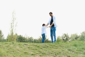 Happy time with father. Family fun concept. Bearded man and cute son Kids smile. Spring time walk with father. photo