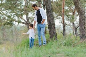 Happy father and little boy walking in summer park. adoption and people concept. photo