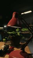 A desk with a lamp and a phone on it video