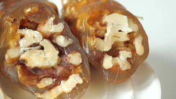 Closeup of a sweet treat made with walnuts and grape molasses, on an orange background video
