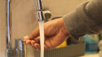 water pouring from a faucet tap in a bottle, drinking pure water concept video